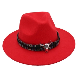Detail of red wool fedora with bohemian woven band and silver bull head pendant charm