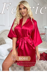 Detail of red satin robe with V-neckline and smooth silk texture on indoor background