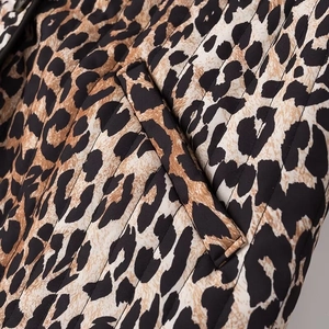 Detail view of leopard print quilted jacket with slanted pocket and high-quality stitching