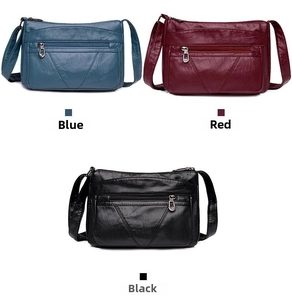 Trois sacs bandoulière en cuir souple bleu, rouge et noir avec zips en forme de cœur