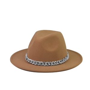 Close-up of a camel wool fedora hat featuring a stylish black and white marble chain