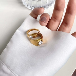 Luxurious gold gear design couple rings with one carat diamond set on silk fabric