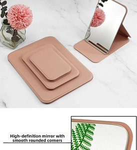Detail of pink PU leather makeup mirror showing smooth edges and foldable stand design