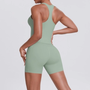 Close-up of racerback sports top and high-waist shorts in matte sage green fabric