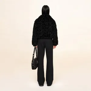 Full back view of a model in black flared trousers with minimalist streetwear style