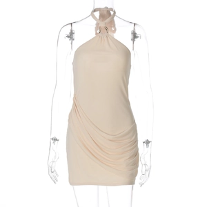 Detail of light beige halter neck dress featuring ruched fabric and asymmetric hem design