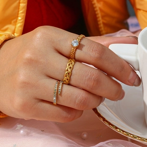 Detailed view of three 18k gold plated zircon rings on model's fingers