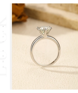 Macro shot of 2 carat moissanite ring with six-prong setting on polished silver band