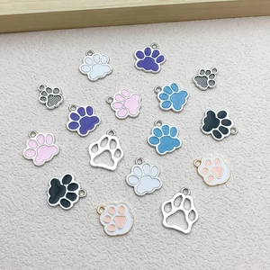 Macro shot of colorful enamel cat and dog paw pendants for DIY jewelry accessories