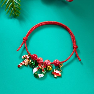 Close-up of handmade red woven Christmas bracelet with candy cane and wreath charms