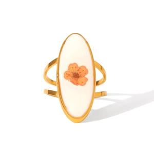Detail of vintage gold ring featuring a real orange dried flower in white oval resin