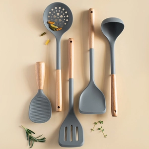 5-piece grey silicone kitchen utensil set with wooden handles on a beige background