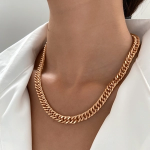 Collana a catena cubana dorata da uomo indossata da un modello con camicia bianca