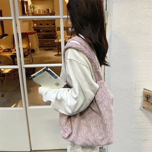 Detail of soft lavender plush tote bag showing long faux fur texture and wide shoulder strap