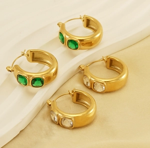 Detailed view of 18K gold plated thick hoop earrings with green emerald and clear zirconia
