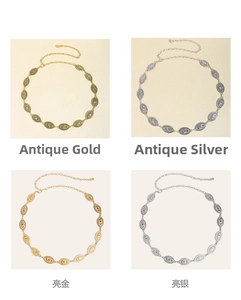 Detail view of retro carved metal waist chains in antique gold and silver finishes