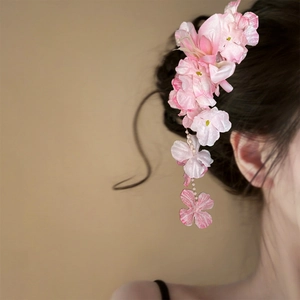Elegant pink fabric flower hair clip with dangling tassels for a sweet look