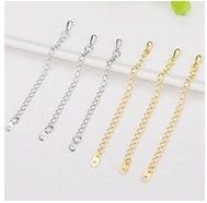 Detailed view of gold and silver extension chains with teardrop charms for jewelry making