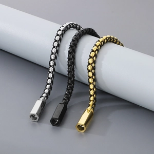 Detailed view of woven leather bracelets with silver, black, and gold metal accents