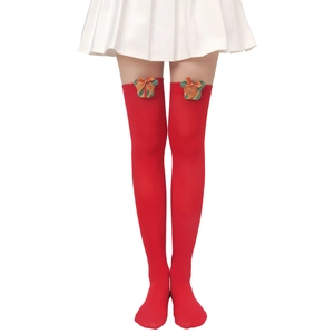 Detail of red over-knee stockings with Christmas gift box and gold glitter bow decoration