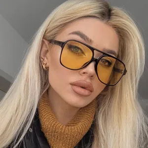 Retro pilot sunglasses with large frames, yellow transparent lenses and metal hinges