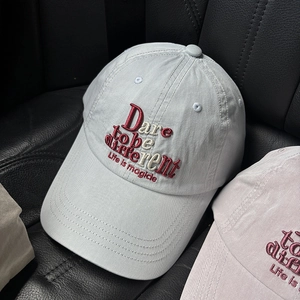 Close-up of light grey baseball cap featuring premium 3D embroidery and twill cotton texture