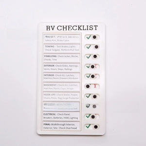 Macro view of white RV checklist board with 10 sliding tabs for daily task tracking