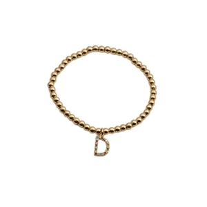Detailed macro view of gold beaded bracelet featuring a colorful rhinestone D initial charm
