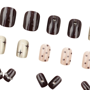 Press-on toenails featuring brown stripes, gold stars, dots and pearl rhinestones