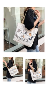 Detail of cream canvas tote bag featuring cute cartoon cats and HELLO text print