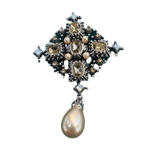 Vintage baroque cross brooch with amber crystal and teardrop pearl pendant on white background