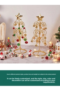 Detail of gold metal wire Christmas trees with colorful bells and star toppers for table