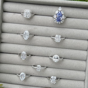 Detailed close-up of S925 silver rings with various gemstone cuts in a grey jewelry box