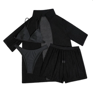 Detailed macro view of black mesh texture and ribbed fabric on three-piece beachwear set