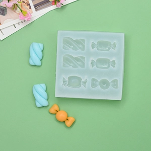 Light blue 6-cavity silicone candy mold with spiral and marshmallow shapes for baking