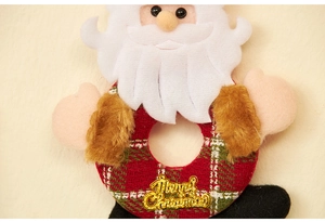Close-up of Santa plush ornament with red plaid ring and golden Merry Christmas sign