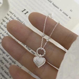 Detail of s925 silver heart pendant with textured pleats and beaded O-chain