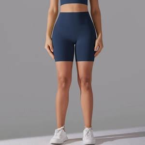 Close-up of high-waisted navy blue yoga shorts showing seamless front and stretch fabric