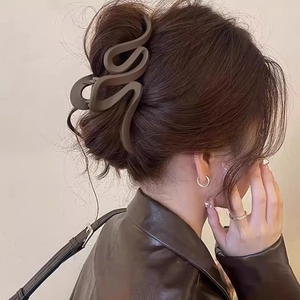 Matte coffee brown large S-shaped wave hair claw clip for elegant bun hairstyles