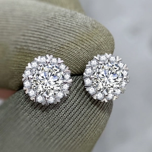 Macro shot of halo style snowflake earrings featuring brilliant round-cut cubic zirconia