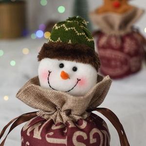 Close-up of a festive snowman Christmas gift drawstring bag with rustic knit textures