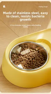 Detail of yellow pet food bowl with stainless steel insert on warm wood floor