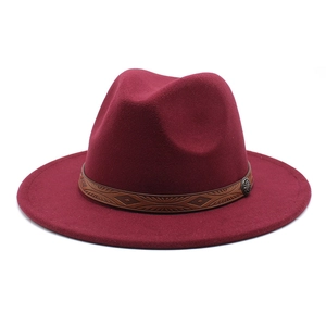 Close-up of wine red wool fedora hat featuring a brown ethnic patterned leather band