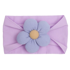 Detail of lavender purple nylon baby headband with knitted flower and yellow button