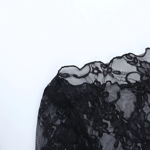 Detail of delicate black floral lace fabric with elegant scalloped edges on sleeve