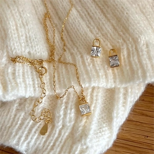 Close-up of S925 sterling silver gold-plated square zircon necklace and stud earring set