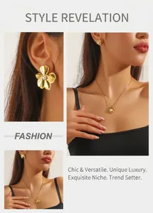 Close-up of gold-plated vintage heart and shell pendant with pearl necklace and earring set