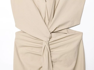 Detail view of khaki midi dress featuring waist knot design and side cutout details