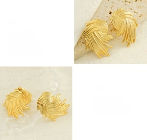 Close-up of golden spiral woven earrings showing high-gloss polished texture and finish