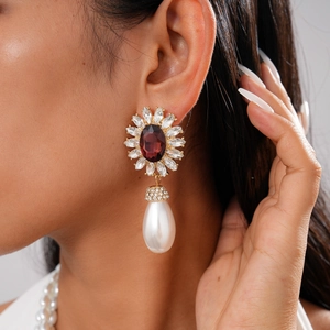 Gros plan détaillé de la boucle d'oreille vintage avec cristal rouge et perle poire